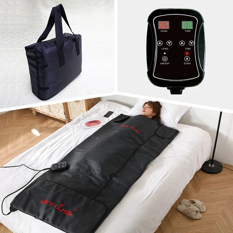 Person lying in an infrared sauna blanket at home; simple setup and foldable design.